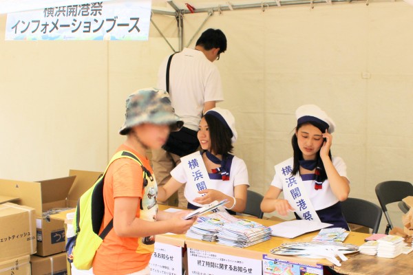 お客さんのうちわを配る横浜開港祭親善大使の竹森みずほさんと宮島麻理奈さん（JR桜木町駅前）